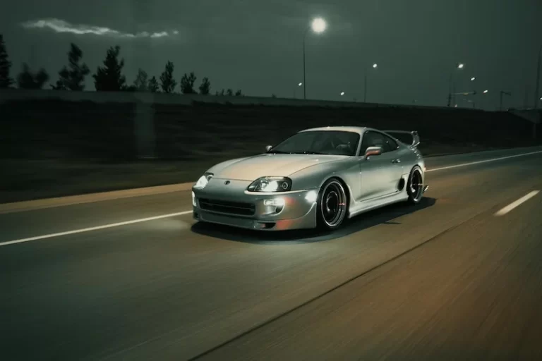 Toyota Supra driving at high speed on the road.